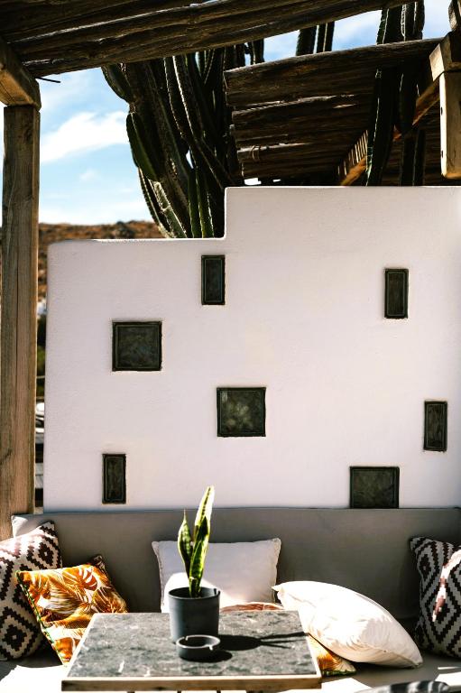 a table with a potted plant on a patio at Sea Side Studios & Houses in Kalo Livadi