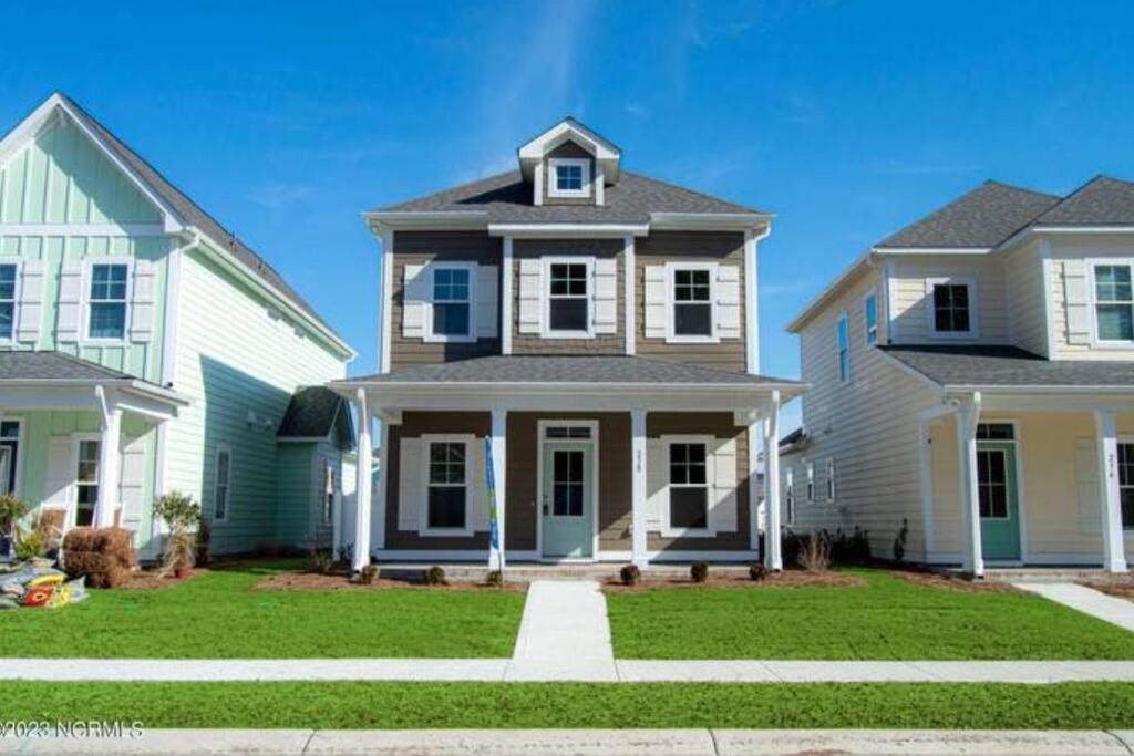 a house with two houses and a yard at Sparrows Nest 3br 2 and half bath beach cottage in Beaufort
