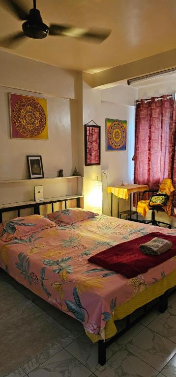 a bedroom with a large bed in a room at Laxmi Happy Home in Pune