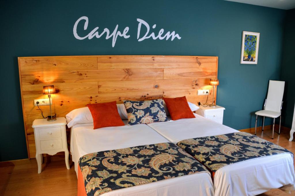 a bedroom with a large bed with a sign on the wall at CasaMarichelvas in San Asensio