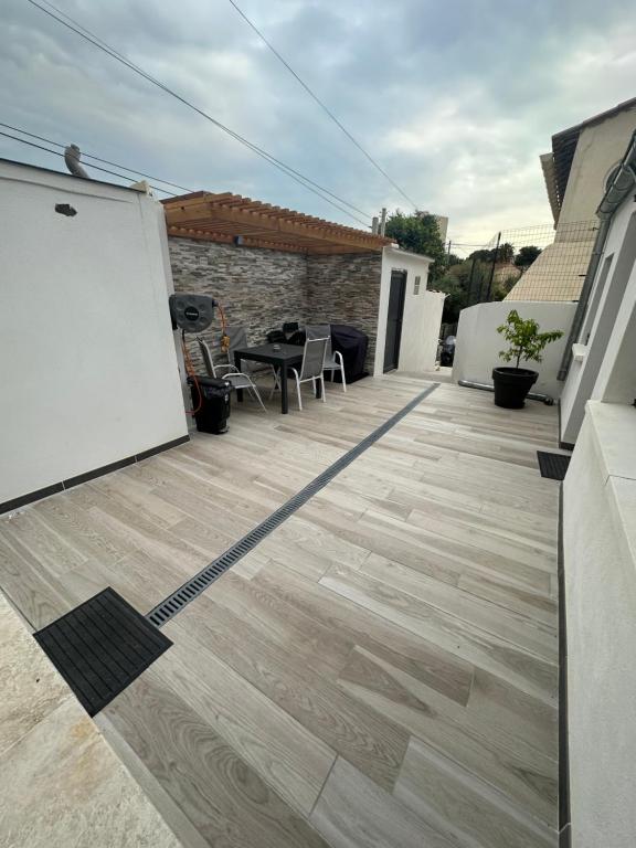 une terrasse avec une table et des chaises sur une maison dans l'établissement Maison 5 couchages bien située, à Marseille