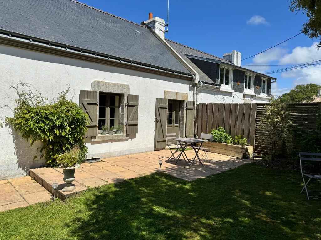Cette maison dispose d'une terrasse et d'une table dans la cour. dans l'établissement Le penty, à Ploemeur