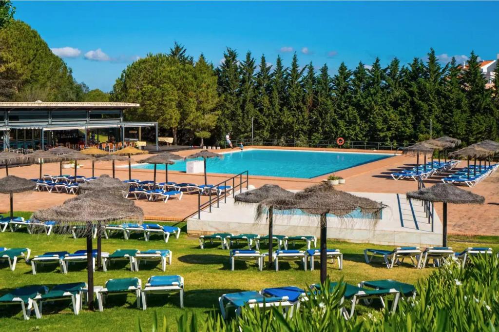 a swimming pool with chairs and umbrellas and a resort at Marina Park 202 in Lagos