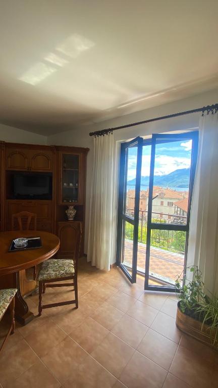 a living room with a door open to a patio at Casa Blue lake in Gravedona