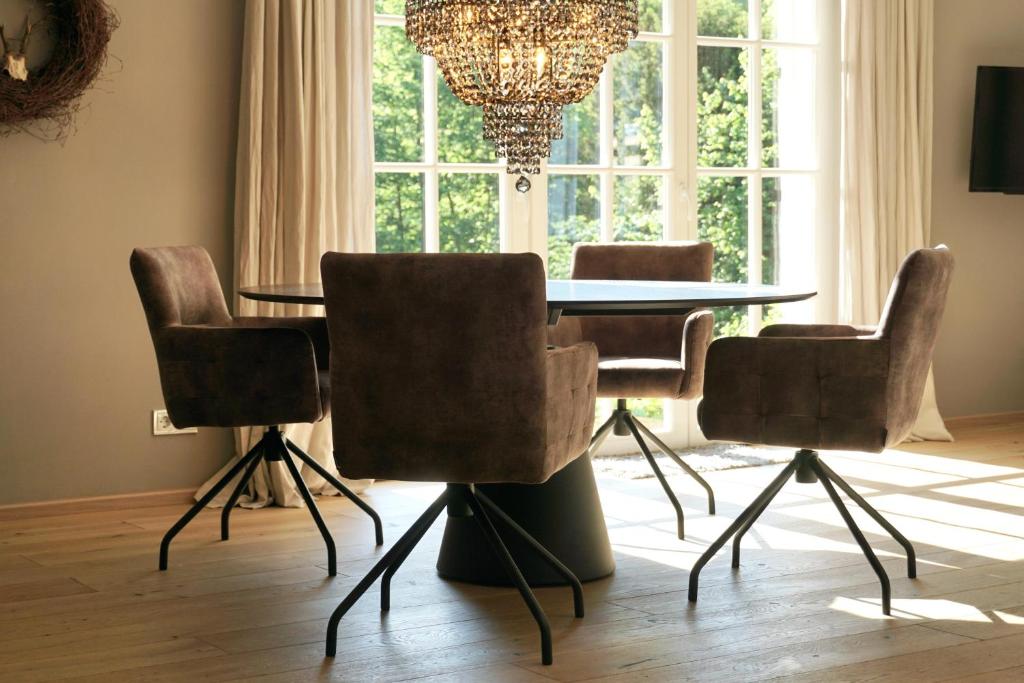 a dining room with a table and chairs and a window at Haus Gipfel-Glück in Goslar