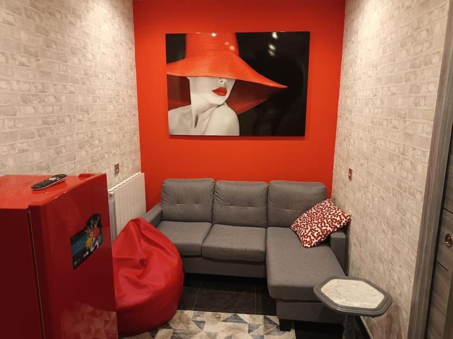 a living room with a couch with a hat on the wall at OUH Candy Box in Bilbao