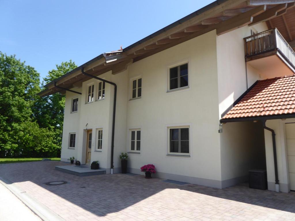 a large white building with a balcony at Ferienwohnungen Florian Pletzenauer in Gstadt am Chiemsee