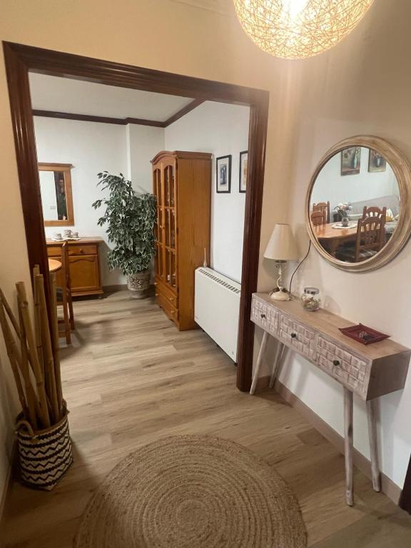 a hallway with a mirror and a table at Puerto de Bueu, Centro in Bueu