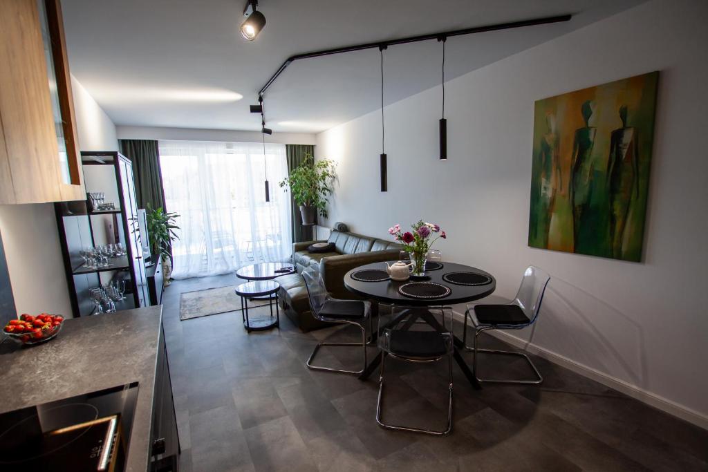 a living room with a table and a couch at Apartament Na Stoku Kielce in Kielce