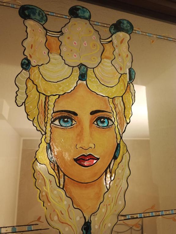a painting of a woman with food on her head at Cuore e Mare Ortigia in Syracuse