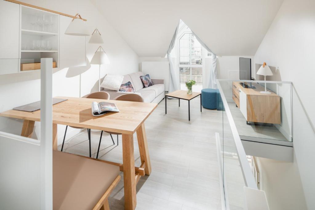 a living room with a table and a couch at Nordstrandperle Ap O3 in Norderney