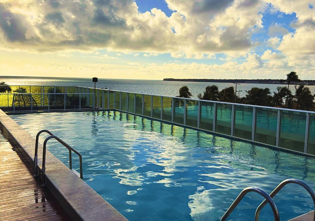 a swimming pool with a view of the water at Nord Luxxor Tambaú in João Pessoa