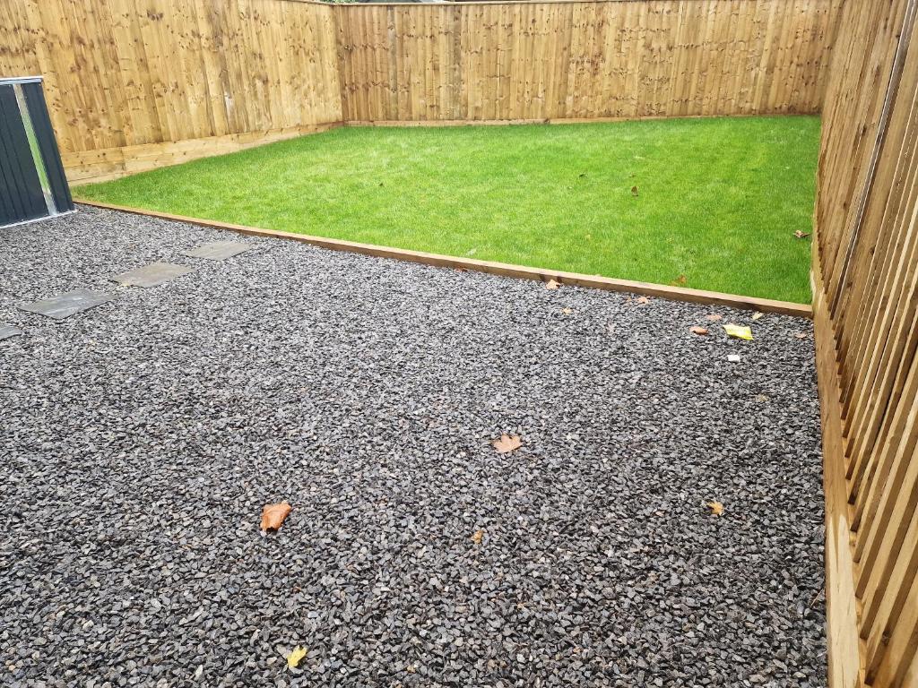 a backyard with a fence and a grass yard at Perfect Getaway / Workstay! in Middlesbrough