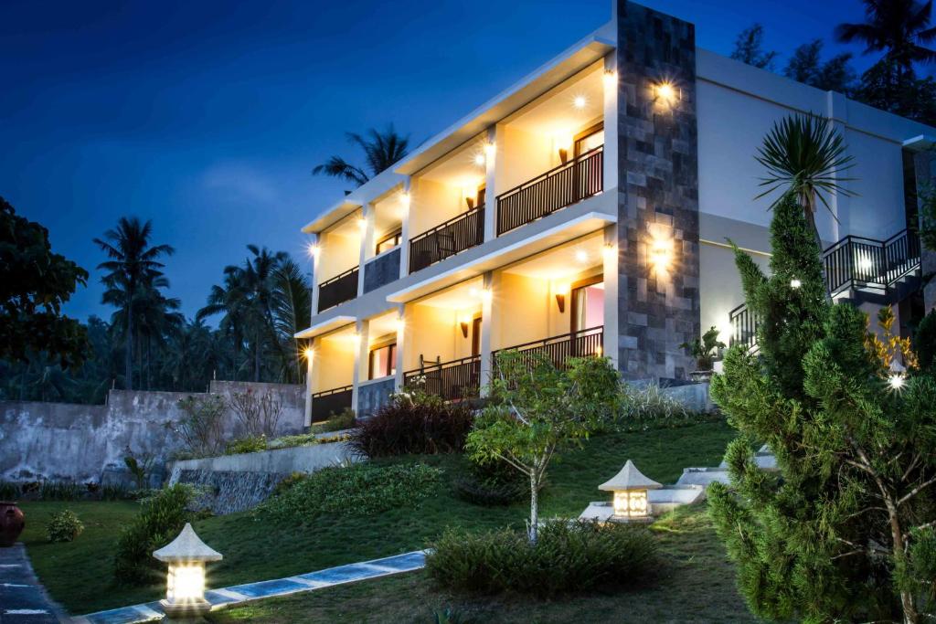 a building with lights in front of it at night at Melasa House in Senggigi 