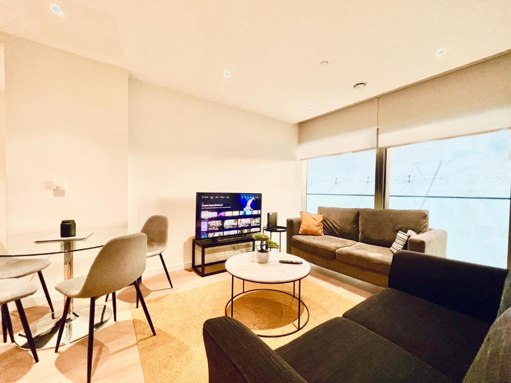 a living room with a couch and a tv at O2 Arena 2Bedroom Flat, London 05 in London