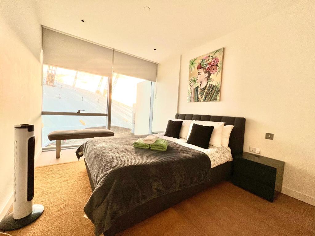 a bedroom with a large bed and a window at Apartments next to the O2 Arena 10 in London