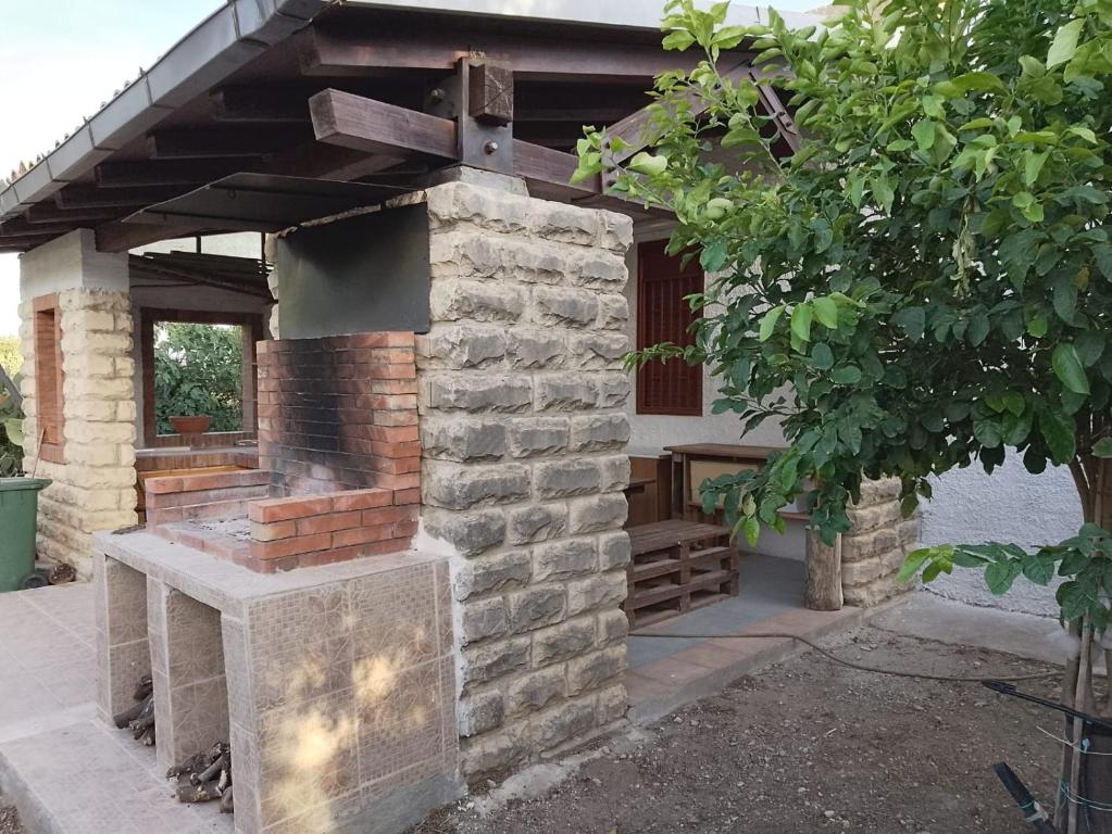 an outdoor brick oven in front of a house at Casa Natura in Avola