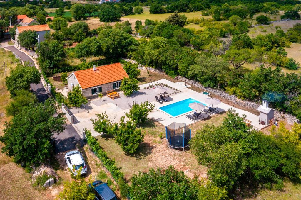 an aerial view of a house with a swimming pool at Villa Lea&Robi in Unešić