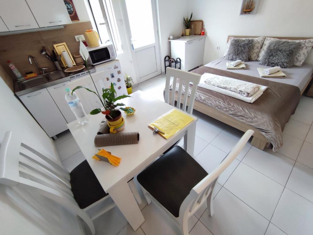 eine kleine Küche mit einem Tisch und einem Bett in einem Zimmer in der Unterkunft Apartments Željka-Dobrota in Kotor