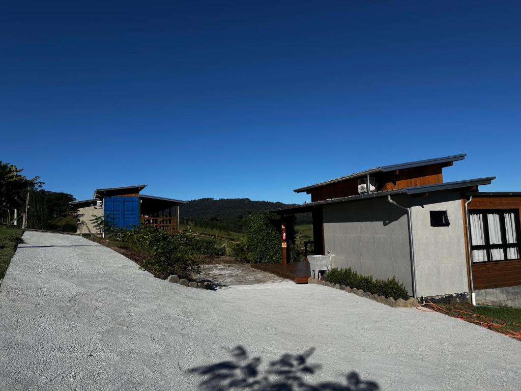 a house on the side of a road at Casa Container - Pousada Container da Montanha VERDE Banheira in Rio Fortuna