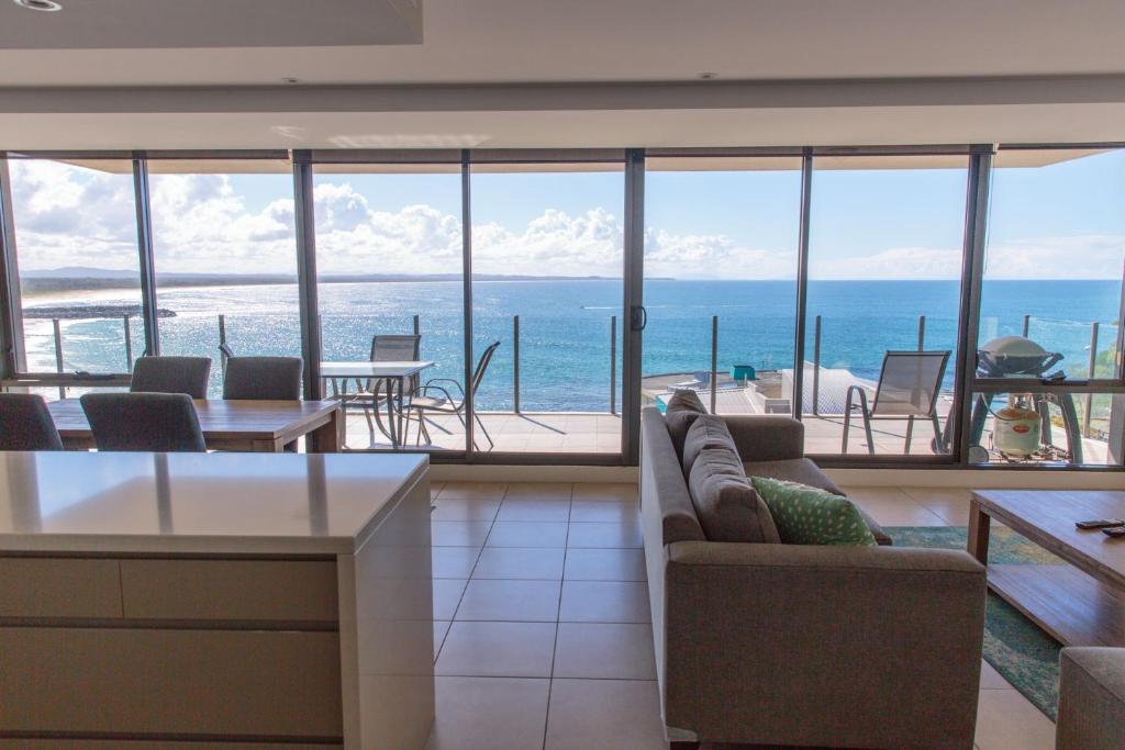 a living room with a view of the ocean at Strand Beachside 903 in Forster