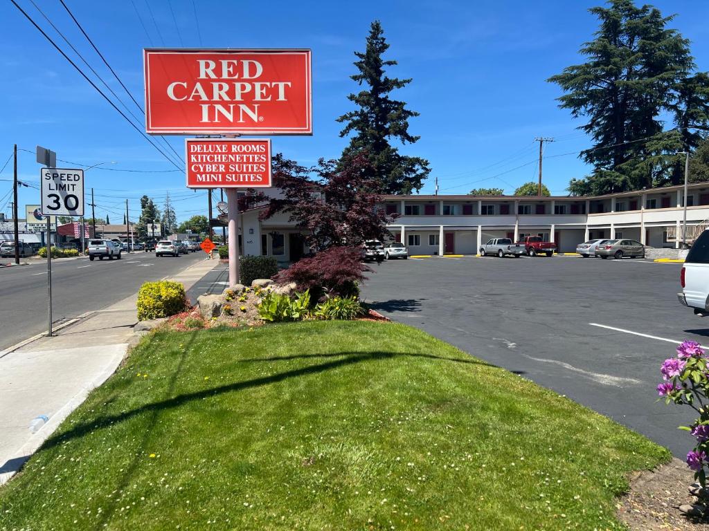 a red carport inn sign on the side of a street at Red Carpet Inn Medford in Medford
