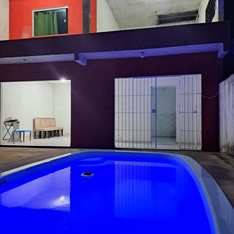 a large blue swimming pool in a room at Casa de praia in Sirinhaém