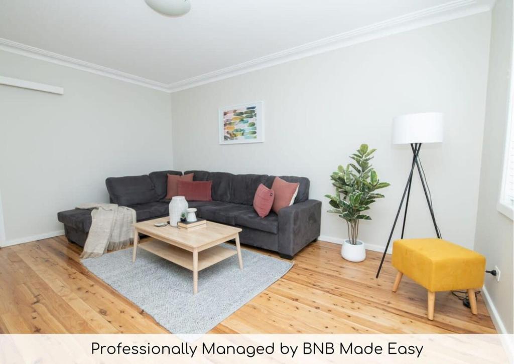 a living room with a couch and a table at Sweet Caroline Sunny & Spacious Sleeps 6 in Orange