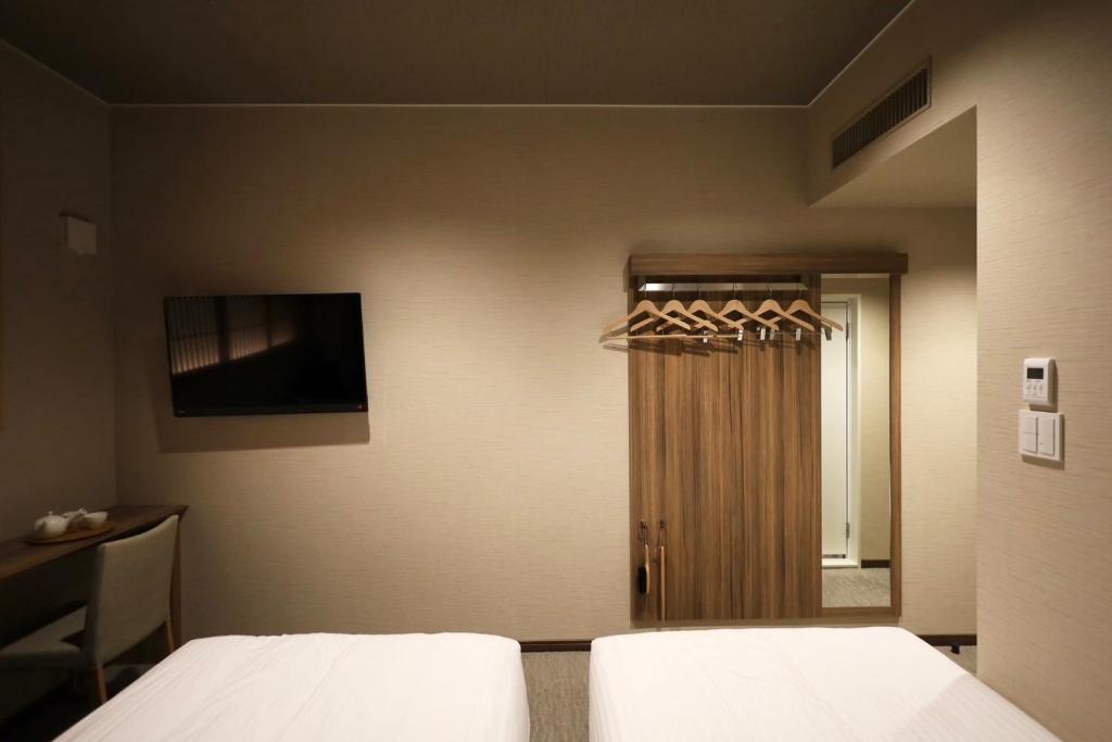 Postel nebo postele na pokoji v ubytování HOTEL CUORE Kyoto Shijo Omiya
