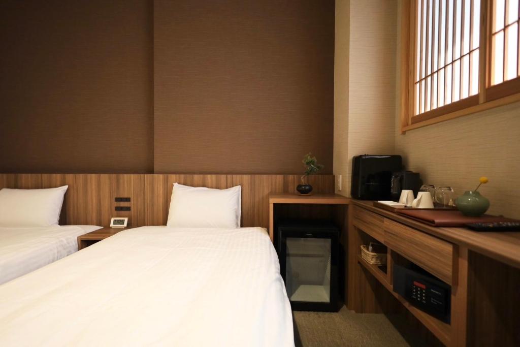 Postel nebo postele na pokoji v ubytování HOTEL CUORE Kyoto Shijo Omiya