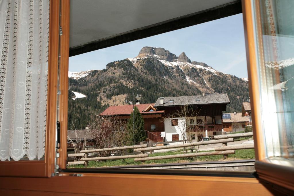 a view of a mountain from a window at Appartamento Doleda in Canazei