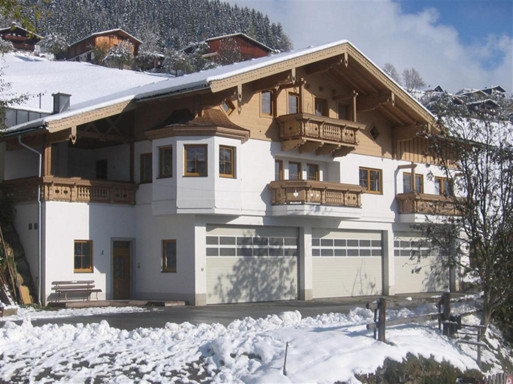 a house with a balcony in the snow at Chalet in Mittersill near Ski Slopes in Mittersill