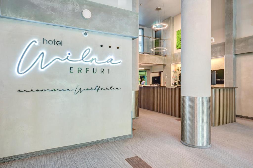 a sign in the lobby of a hotel nilla erin resort at Hotel Wilna in Erfurt