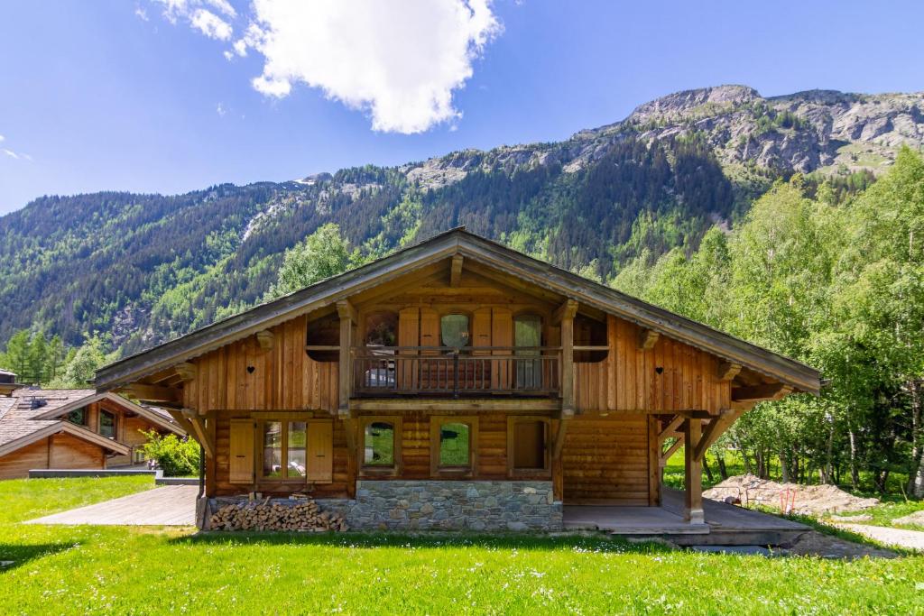a log cabin in the mountains with a balcony at Chalets d'en haut - Bonheur - Happy Rentals in Chamonix-Mont-Blanc