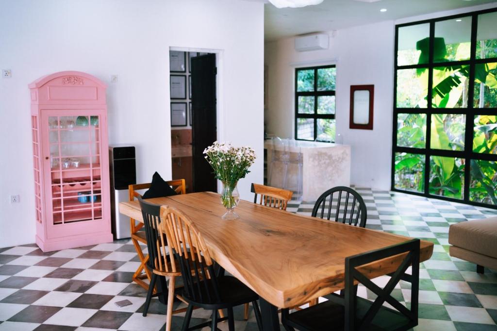 a dining room with a wooden table and chairs at PROMO! 2BRV With premium Pool in Uluwatu