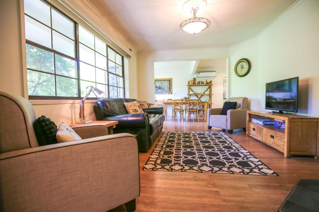 a living room with a couch and a tv at Abbeville In Bright in Bright