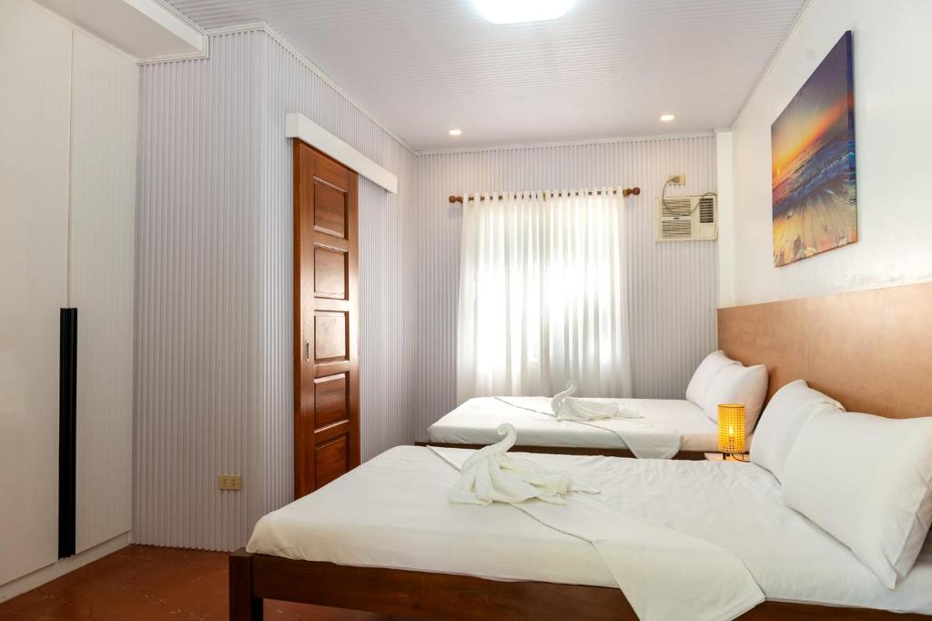 Postel nebo postele na pokoji v ubytování Costa Liz Island Resort