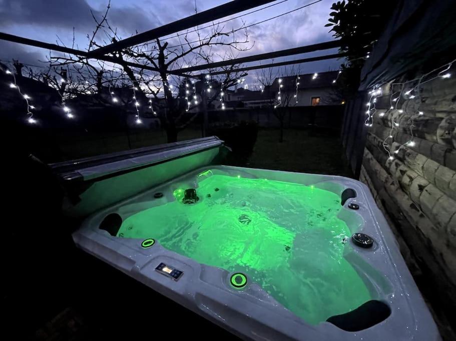 a jacuzzi tub filled with green water at night at Belle maison rénovée avec jacuzzi in Saint-Rémy