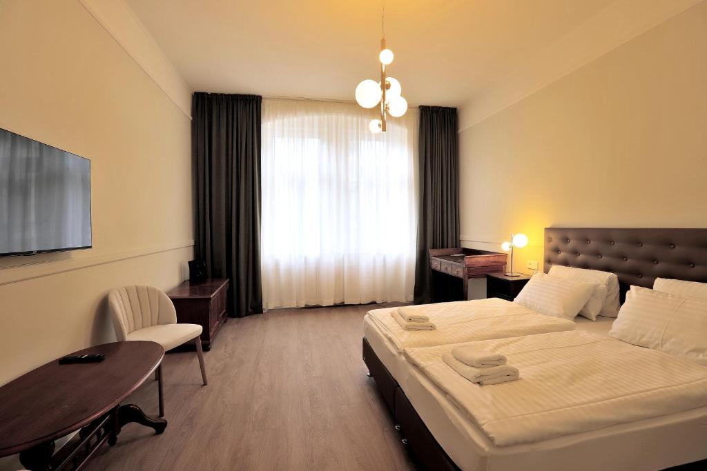Postel nebo postele na pokoji v ubytování Kavalír Apartments