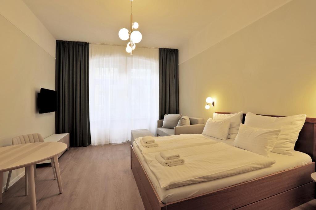 Postel nebo postele na pokoji v ubytování Kavalír Apartments