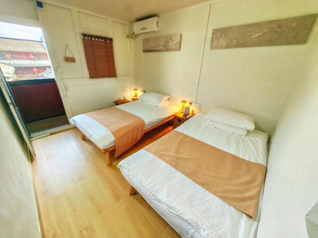 Postel nebo postele na pokoji v ubytování Tulou Fuyulou Changdi Inn