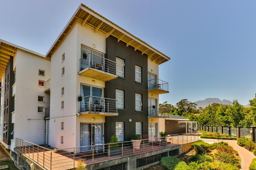 an exterior view of a building with balconies at WINK Aparthotel Quiver Tree in Stellenbosch