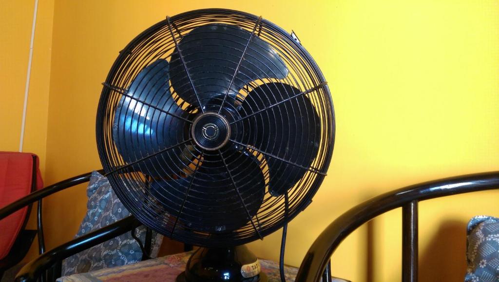 a blue fan sitting on top of a bed at PianoPiano B&amp;B in Jincheng
