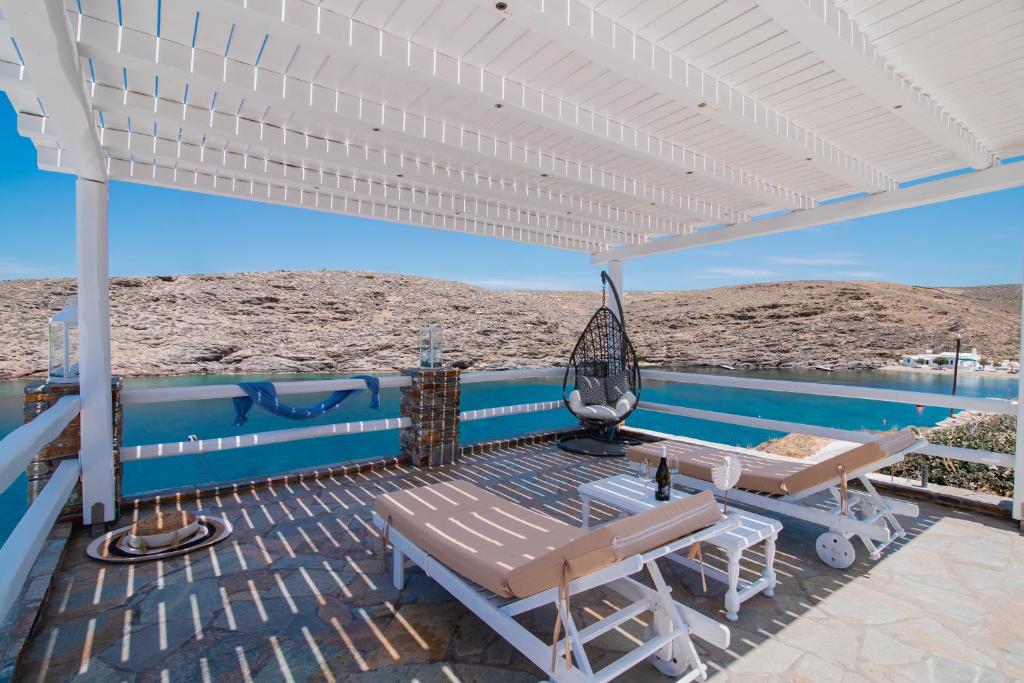 a patio with a hammock and a view of the desert at KL , Cozy Suite II in Kithnos