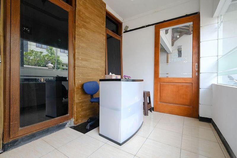 a room with a door and a table and a chair at Wisma 812 Khusus Putra for Male Only in Bandung