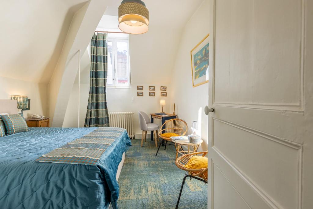 1 dormitorio con 1 cama, mesa y sillas en Maison Garnier Hôtel de Charme Biarritz en Biarritz