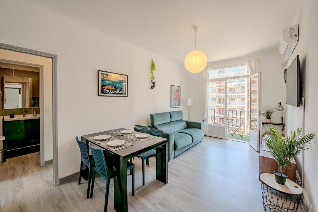 un salon avec une table et un canapé dans l'établissement Le Mayol - T3 Clim & Balcon, à Toulon