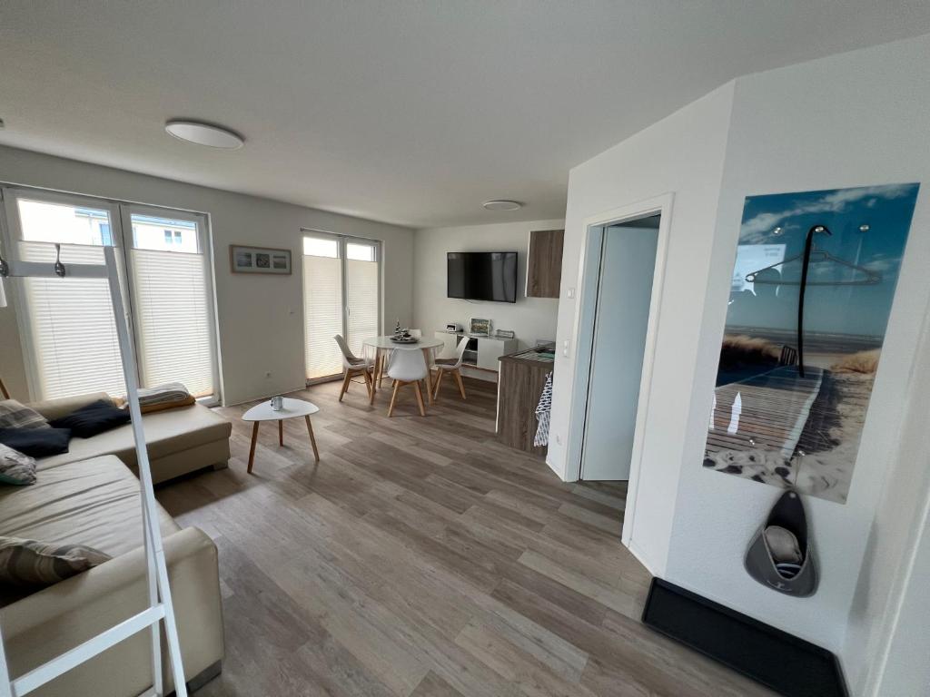 a living room with a couch and a table at Tamaris Resort in Graal-Müritz