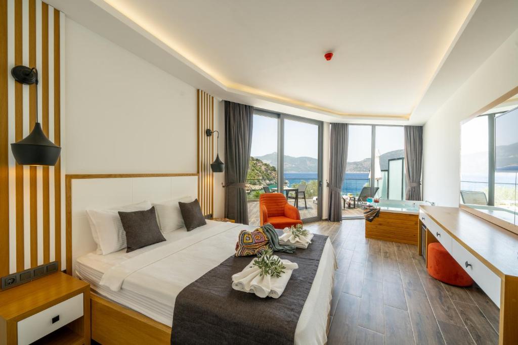 a hotel room with a bed and a desk at Kalkan Beach Park Hotel in Kas