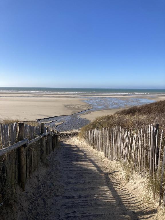 une clôture en bois sur une plage au bord de l'océan dans l'établissement Maison familiale proche Nausicaa, à Boulogne-sur-Mer